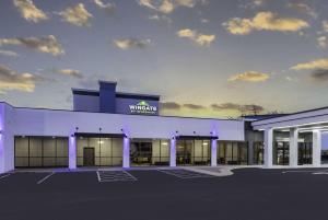 a white building with a warehouse sign on it at Wingate by Wyndham Wichita Airport in Wichita