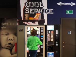 a woman standing in front of a vending machine at Ibis Budget Bilbao City in Bilbao