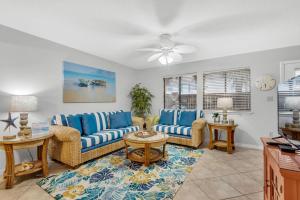 a living room with two couches and a table at Sugar Beach F-26 in Navarre