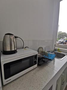 a microwave sitting on top of a kitchen counter at AA Apartment in Koh Samui 