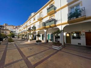 an empty street in a building with potted plants at Casa Calma Los Tajillos - a 150 metros de la playa in Torremolinos