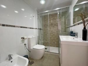 a bathroom with a toilet and a sink and a shower at Casa Calma Los Tajillos - a 150 metros de la playa in Torremolinos +15 photos