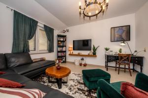 a living room with a couch and a table at Exquisite Villa with Heated Pool, Sauna, Breathtaking Landscape & Panoramic Views in Banjol in Rab