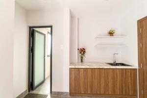 a kitchen with a sink and a counter at Sweet Home gần bãi sau in Vung Tau