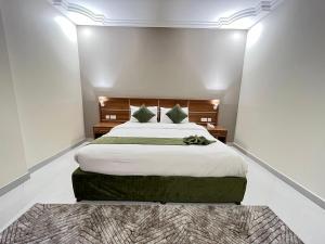 a bedroom with a large bed and a rug at Muscat Hills Hotel in Muscat