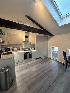 a large kitchen with a skylight in a house at Cosy City Escape in Hull +14 photos