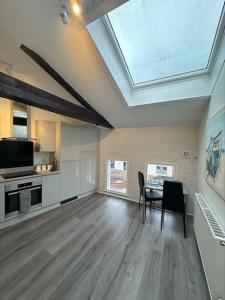 a living room with a table and chairs and a skylight at Cosy City Escape in Hull