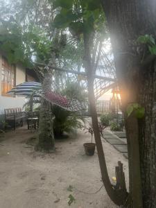 a hammock in the courtyard of a house at Alleppey Beach Garden in Alleppey