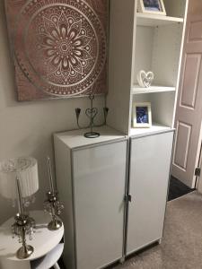 a white refrigerator in a room with a shelf at Sedgefield luxury Apartments. in Sedgefield