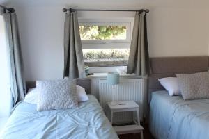 a bedroom with two beds and a window at Close to Snowdon with Mountain views of Snowdonia in Caernarfon