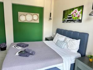 a bed in a room with a green wall at DAFNI LUXURY SUITES in Athens