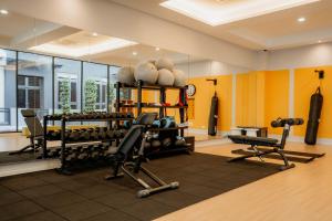 a gym with dumbbells and weights in a room at Stylish Loft Duplex Sunway Grid by Our Stay in Kampong Pendas