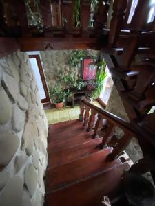 a staircase in a house with a stone wall at Pensiunea Andrei in Borşa