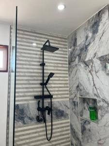 a shower with a shower head in a bathroom at Siargao Residency by Privacy Group in General Luna