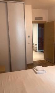 a bedroom with a sliding door and a mirror at DMT Apartament regim hotelier Rin in Bucharest +21 photos