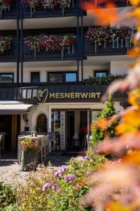 a building with a sign for a messner unit at Hotel Mesnerwirt in Westendorf