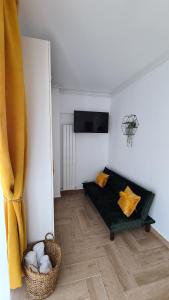 a living room with a couch and a television at SOLMAR Studios in Năvodari