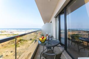 a balcony with a table with fruit on it at SOLMAR Studios in Năvodari