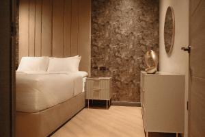 Ένα ή περισσότερα κρεβάτια σε δωμάτιο στο Signature Apartments