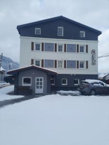 a large building with a car parked in front of it at Шале АНСО in Mykulychyn