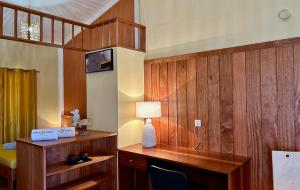 a room with wooden walls and a desk with a lamp at Palombella - Stella Maris Exclusive in Calheta Do Maio