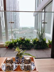 due vasi seduti su un tavolo di fronte a una finestra di Mây Homestay Ecopark a HÆ°ng YÃªn