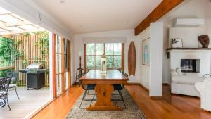 a living room with a wooden table in the middle at Rosemary Cottage in Cape Schanck