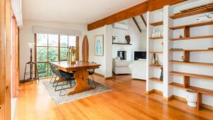 a living room with a wooden table and a desk at Rosemary Cottage in Cape Schanck