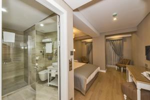 a bedroom with a bed and a shower and a bathroom at Hanna Hotel in Istanbul +115 photos