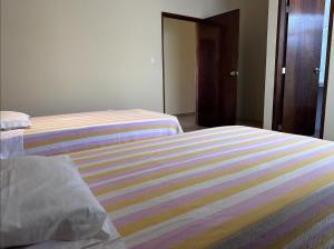 Postel nebo postele na pokoji v ubytování YOLO House Peru
