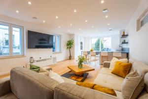 a living room with a couch and a table at Magnifique maison neuve in Lingolsheim