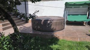a wicker trash can sitting next to a building at Tea House Samokov in Samokov