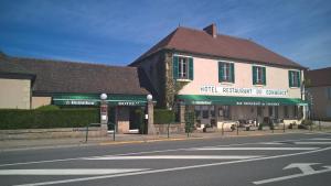 un edificio en la esquina de una calle en Hôtel Restaurant Bar du Commerce - KB HOTEL GROUP, en Tronget