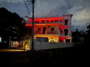 a building with red lights on the side of it at 5 Min Walk To Famous Blue Water Resort And Tourist Area in Maribago