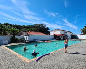 a group of people swimming in a swimming pool at Ocean Crest Villa in Cintsa Mouth West