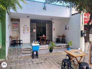 a patio with tables and chairs in front of a building at Pousada Point da Nanda in Juazeiro do Norte