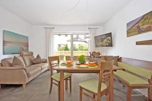 a living room with a table and chairs and a couch at Rusticoy in Oy-Mittelberg