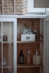 a shelf with soap and flowers on it at La Buena Sombra in Alicante