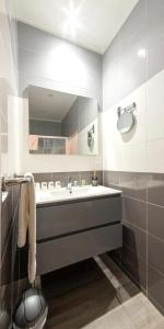 a bathroom with a sink and a mirror at Le Relais de la Poste in Gourdon