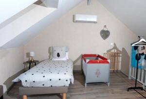 a bedroom with a bed with a teddy bear pillow at Le Relais de la Poste in Gourdon