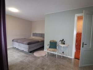 um quarto com uma cama e uma cadeira em Very spacious apartment in a converted farmhouse 