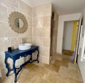 y baño con lavabo azul y espejo. en Appartements Cabiscol en Beaucaire