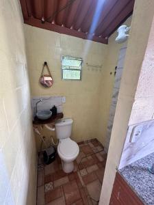 a small bathroom with a toilet and a shower at Hostel Sossego do Garças in Barra do Garças