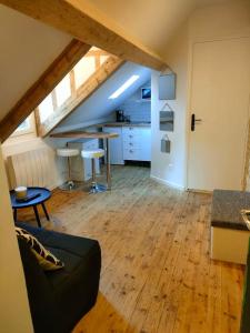 a living room with a couch and a table at Charmant studio typique & cosy au Cœur de Caen in Caen