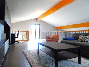 a living room with a couch and a table at Magnifique villa 220m2- Quartier résidentiel Le Carreyrat - 6 à 8 pers - 3 chambres doubles - Grand jardin et terrasses in Montauban