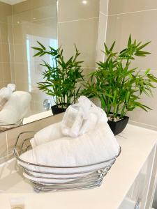 a bathroom with two plants and towels on a counter at Urban Gateway Spacious Apartment with free parking in Bracknell