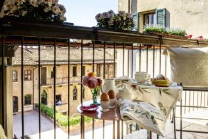 a table on a balcony with a view of a building at Residenza...Cara Giulietta... in Verona