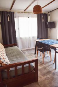 a bedroom with a table and a bed and a dining room at La casa del Álamo in Tandil