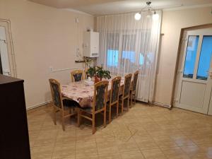 a dining room with a table and chairs and a table and chairsktop at Casa Argentina in Cârțișoara