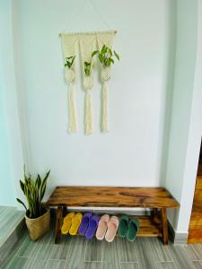 a wooden bench with colorful shoes in a room at Gió Homestay and Coffee in Ấp Khánh Phước (1)